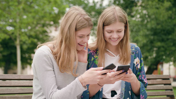 istock Young Ladies Using a Phone in Town 1078134164
