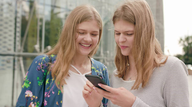istock Young Ladies Using a Phone in Town 1078134286