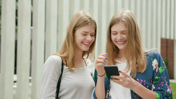 istock Young Ladies Using a Phone in Town 1078134428
