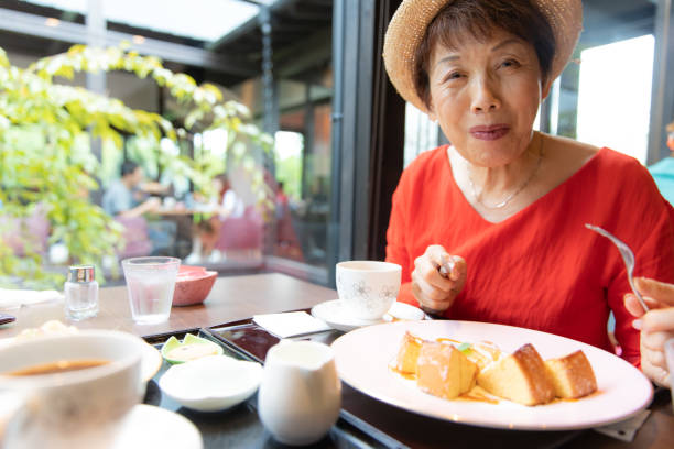 istock Senior woman enjoying coffee and cake 1078138122
