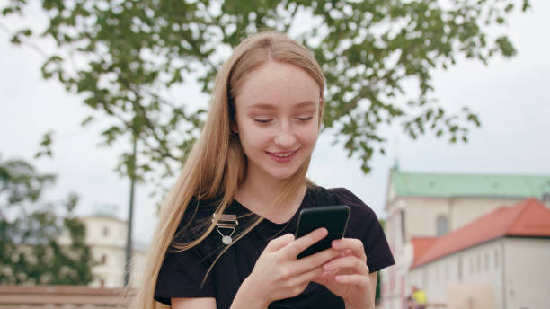 istock Young Redhead Lady Using a Phone in Town 1078139706