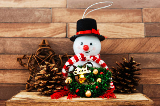istock Snowman with Christmas decoratio on wooden background 1078143884