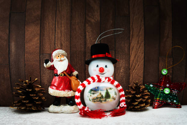 istock Snowman with Christmas decoratio on wooden background 1078143894