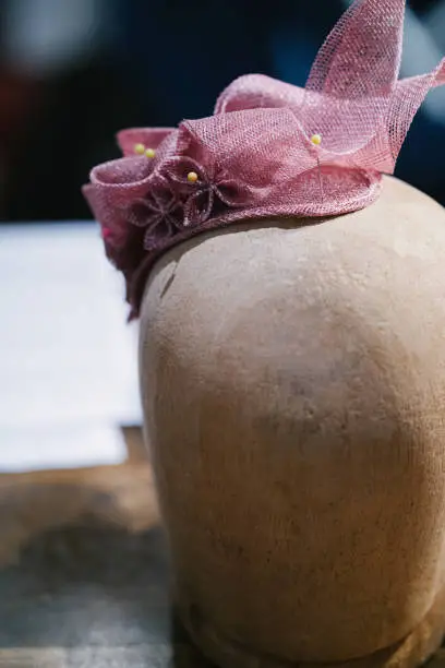 Milliner making handmade customized hats in her workshop.