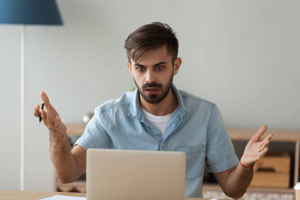 istock Confused male worker shocked seeing warning notice at laptop 1078149304