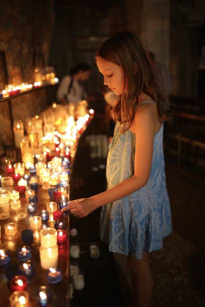 istock Child lighting candle in a church 1078152406