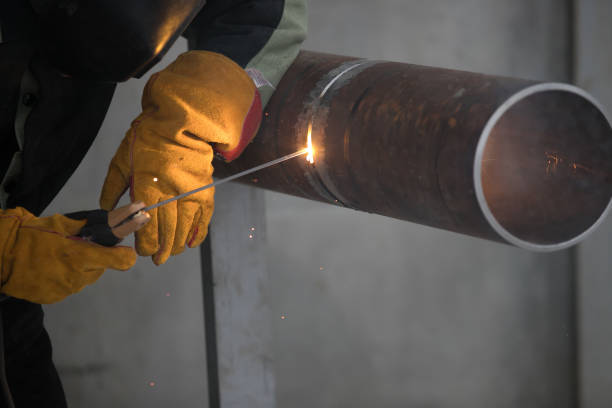 istock Worker welding metal piping using tig welder 1078154114