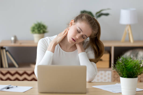 istock Tired girl massaging neck suffering from back pain 1078156236