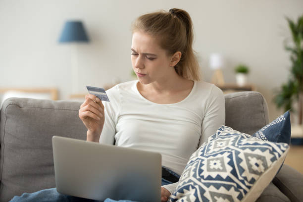 istock Concerned female have problems with credit card shopping online 1078156260