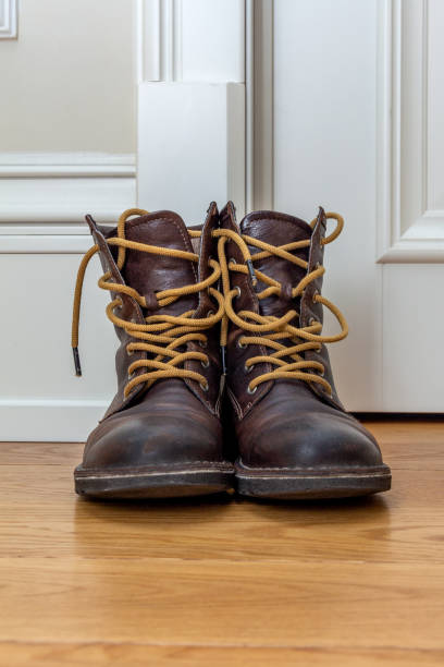 istock brown leather boots on the wooden floor 1078156450