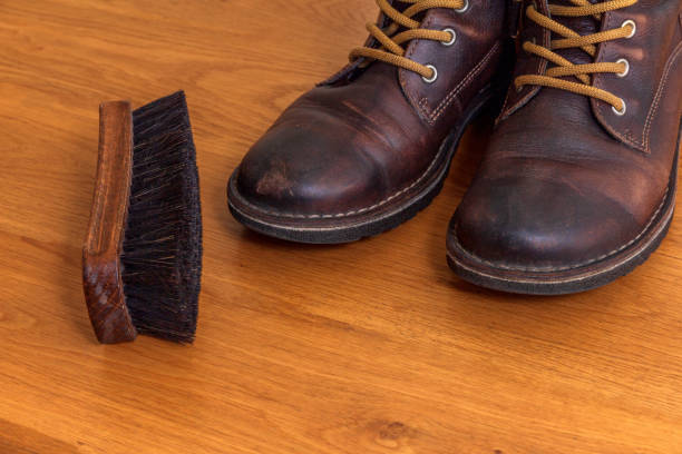istock brown leather shoes and a shoe brush 1078156456