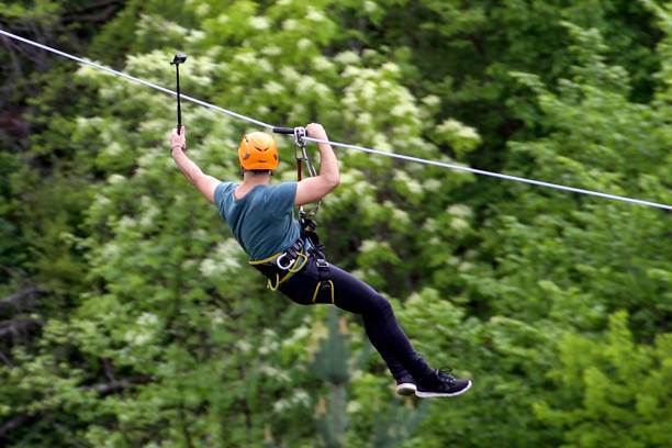 istock Young man on zip line taking a selfie 1078159374