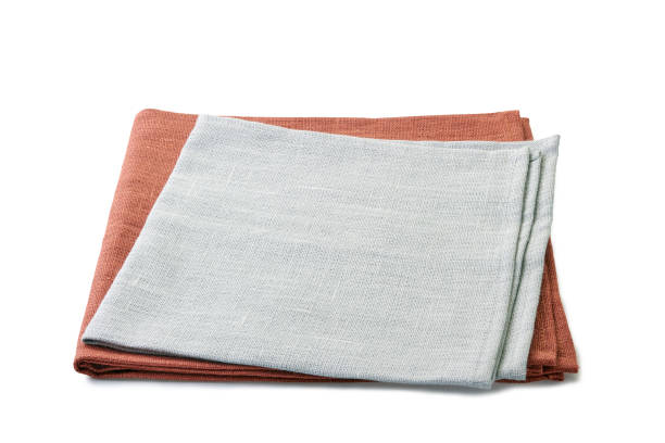 istock Folded brown and gray textile napkins stacked on white background 1078161964