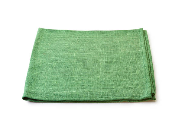 istock Folded green natural textile napkin on white 1078162654