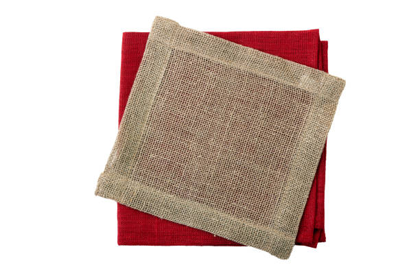 istock Stack of folded red and jute napkins on white 1078162738