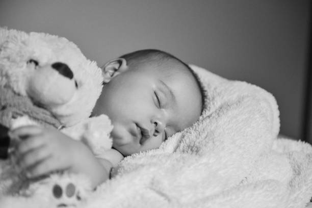istock Black and white image of resting baby boy 1078162770