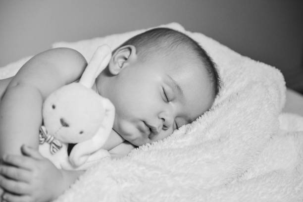 istock Black and white image of resting baby boy 1078162772