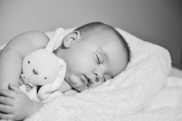 istock Black and white image of resting baby boy 1078162776