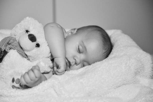 istock Black and white image of resting baby boy 1078162780