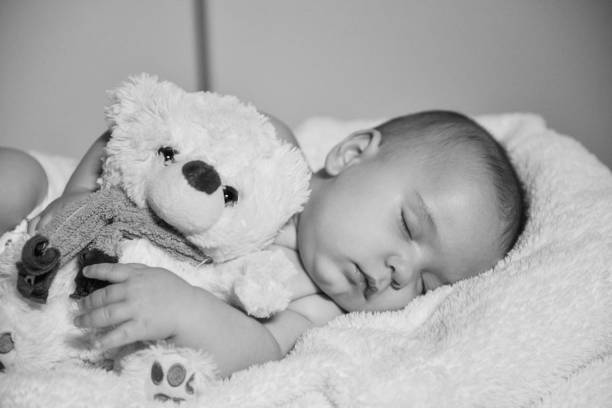 istock Black and white image of resting baby boy 1078162782