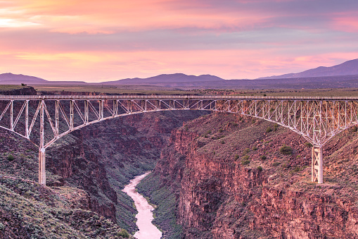 A colorful sky forms the backdrop to the bridge spanning the Rio Grande Gorge near Taos, New Mexico.