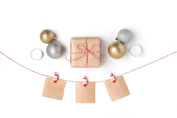istock Golden and silver balls, gift, candles, notes with wish on clothespins, Top view White Background Christmas New Year 1078167786