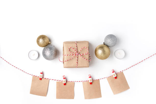 istock Golden and silver balls, gift, candles, notes with wish on clothespins, Top view White Background Christmas New Year 1078167814