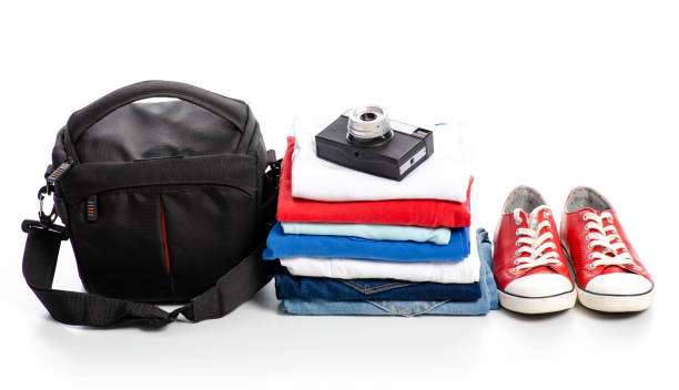 istock Stack of clothes and red sneakers camera 1078169338