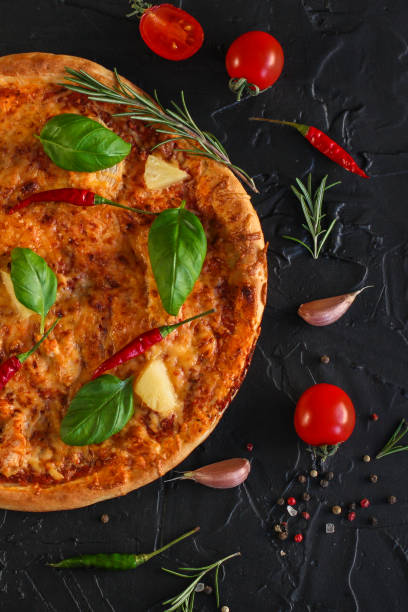 istock pizza, pineapples, chicken, tomato sauce, vegetables, basil (pizza ingredients). food background. copy space 1078171382