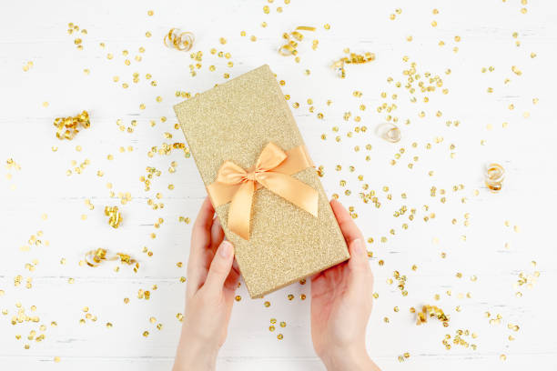 istock Golden gift box with confetti 1078171530
