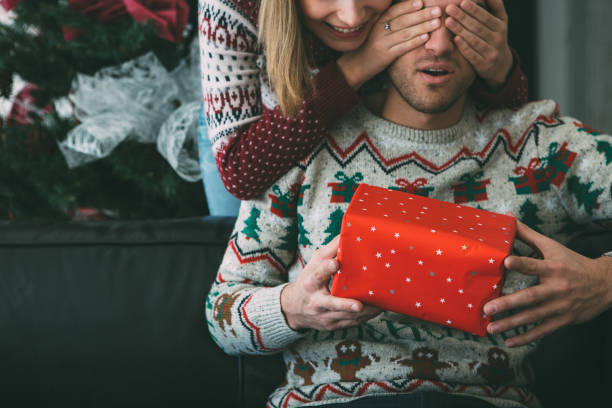 istock Young woman surprise man with Christmas gift 1078172066