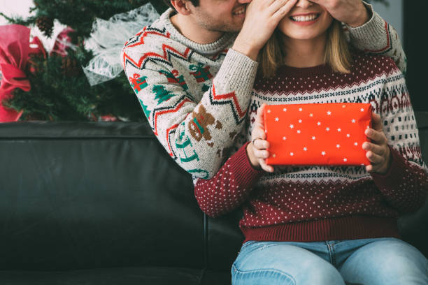 istock Young man surprise woman with Christmas present 1078172110