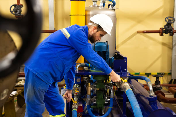 technician maintenance of industrial oil pump on factory - service rig imagens e fotografias de stock
