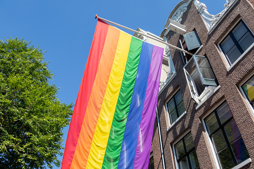 Gay Pride, Rainbow flag of LGBT community on building in Amsterdam, the Netherlands