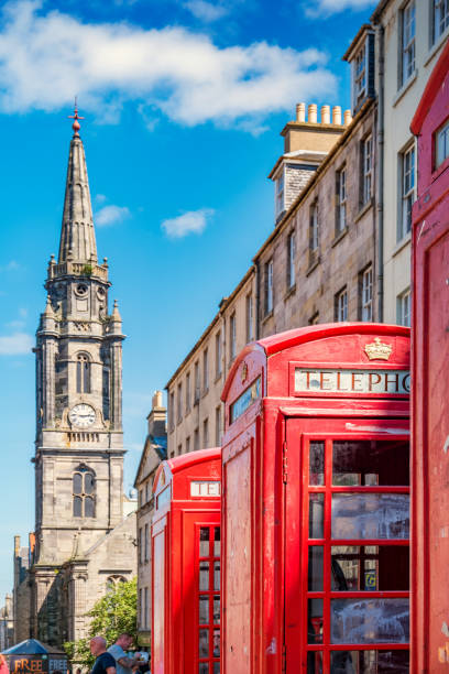 Red telephone booths and Tron Kirk Royal Mile Edinburgh Scotland Red telephone booths and Tron Kirk on the Royal Mile in downtown Edinburgh, Scotland, UK on a sunny day royal mile stock pictures, royalty-free photos & images