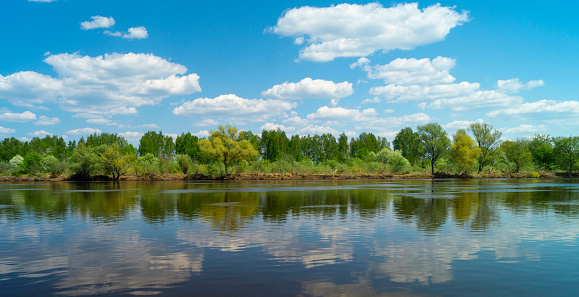 Year landscape with river in rural terrain on background blue sky
