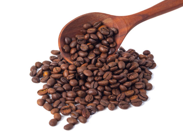 istock Roasted coffee beans on a wooden spoon on a white background 1078186008