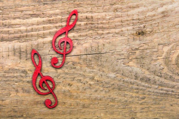 istock Red wooden treble clef on wooden background, copy space 1078186548