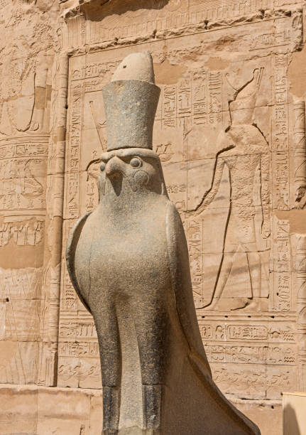 istock Hieroglyphic carvings on an ancient egyptian temple wall with statue 1078188332