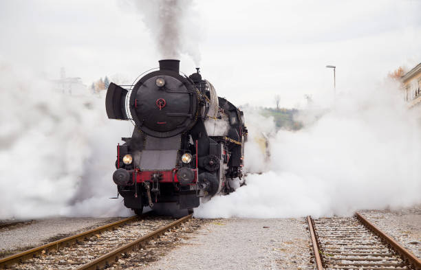 Old Steam train - locomotive Old Steam train - locomotive is leaving the Railway Station at Nova Gorica, Slovenia nova gorica stock pictures, royalty-free photos & images