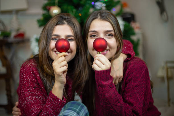 istock Playful girlfriends making noses with baubles 1078201236
