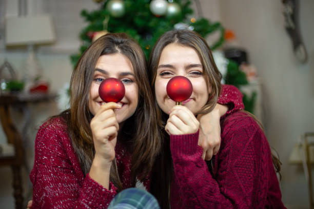 istock Playful girlfriends making noses with baubles 1078201238