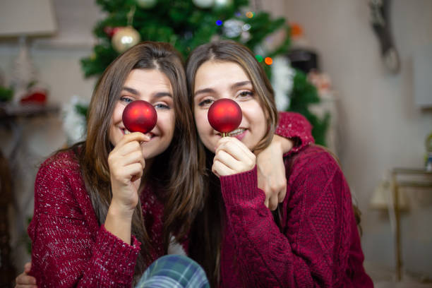 istock Playful girlfriends making noses with baubles 1078201262