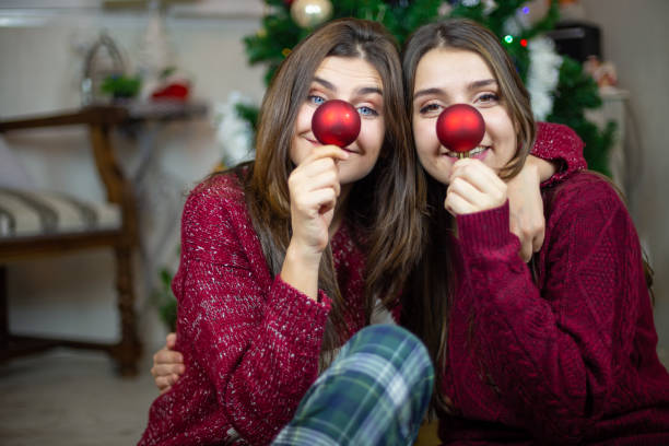 istock Playful girlfriends making noses with baubles 1078201286