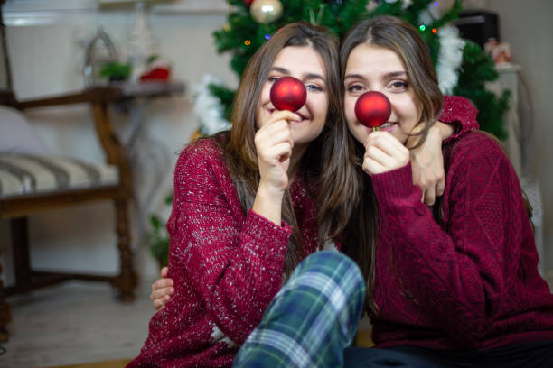 istock Playful girlfriends making noses with baubles 1078201290