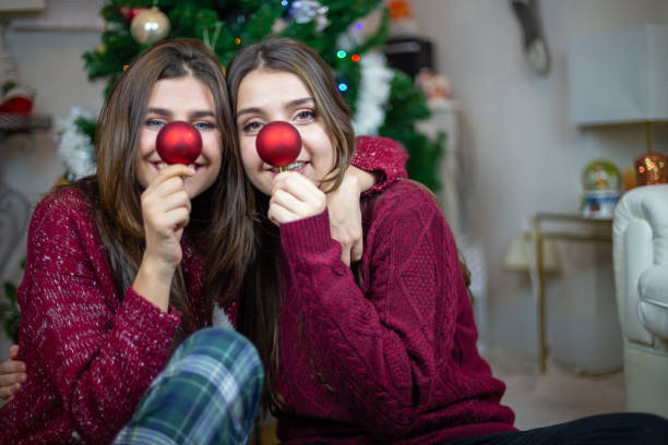 istock Playful girlfriends making noses with baubles 1078201354