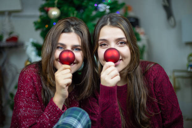 istock Playful girlfriends making noses with baubles 1078201374