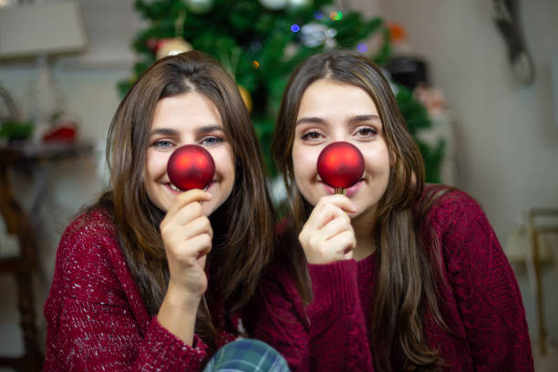 istock Playful girlfriends making noses with baubles 1078201404