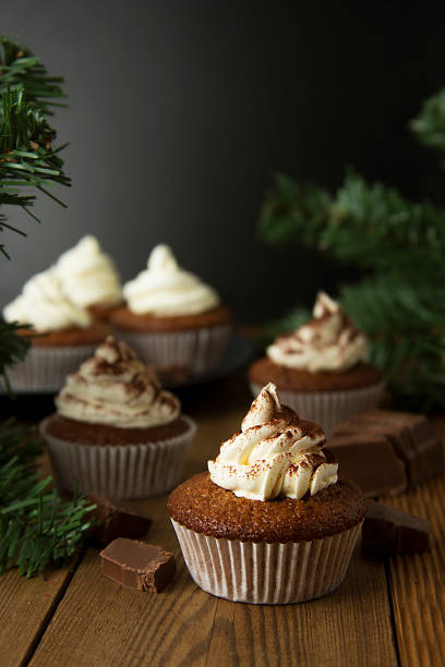 istock Chocolate cupcakes with whipped cream on rustic wooden table. Homemade dessert. 1078201672