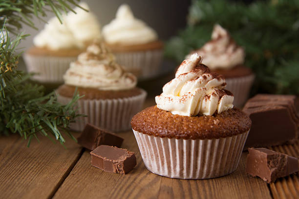istock Chocolate cupcakes with whipped cream on rustic wooden table. Homemade dessert. 1078201748